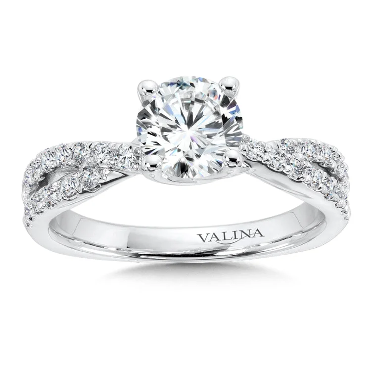 Engagement ring with diamond accented crisscross shoulders in 14k white gold.